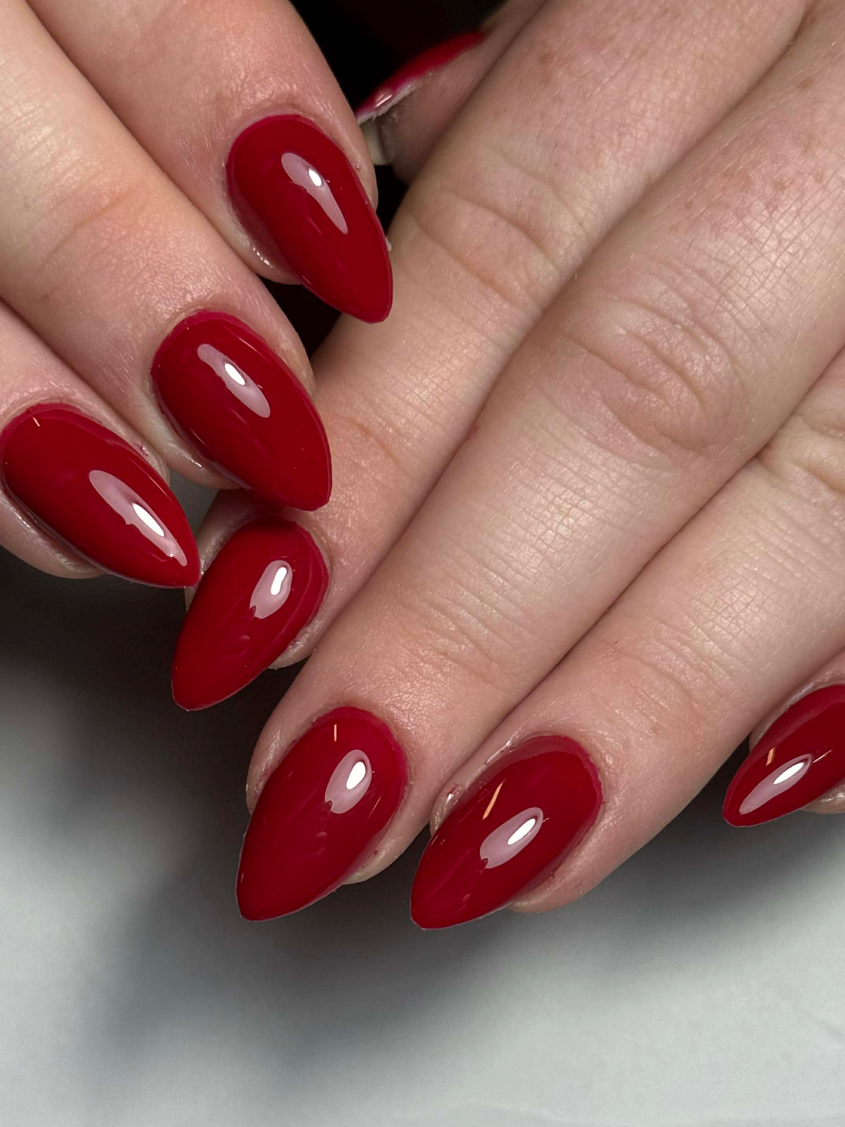 Deep red almond gel set with a high gloss finish